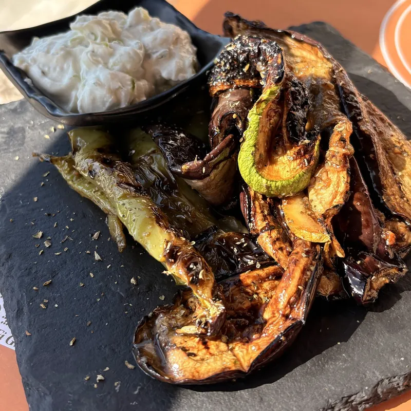 Charred aubergine, courgette and peppers with tzatziki on slate